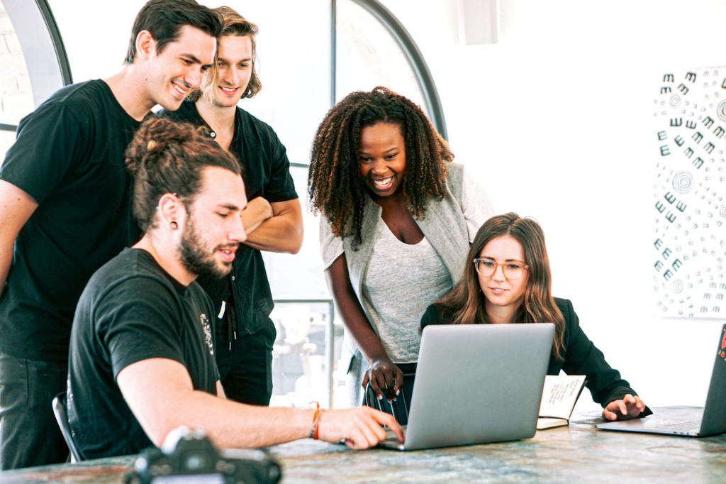 five people at the office desk