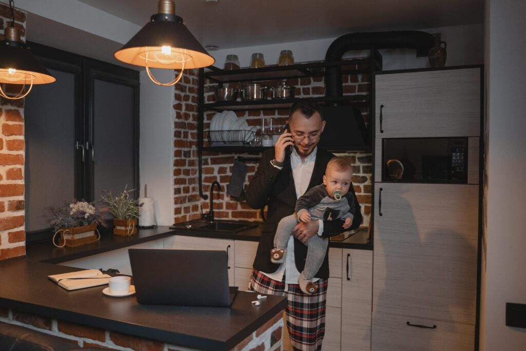 An IT staffer with a child in a kitchen