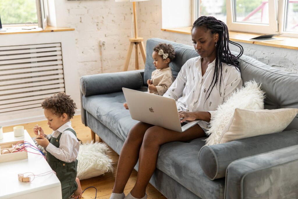 Remote worker in IT Support with their family in a living room