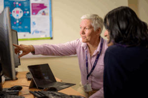 Outsourcing IT support, managers picking candidates through their profiles on the computer screen